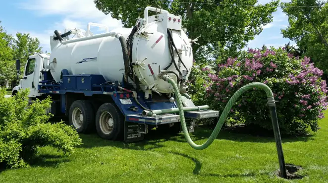 Professional vacuum truck performing residential drainage and septic maintenance in Charleston, SC