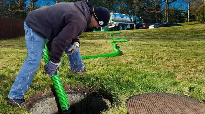 Service technician performing residential septic pumping and drainage maintenance in Charleston, SC